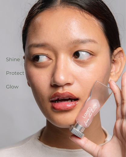 Woman holding a skincare product with 'Lawm from the hills' branding on a gray background.
