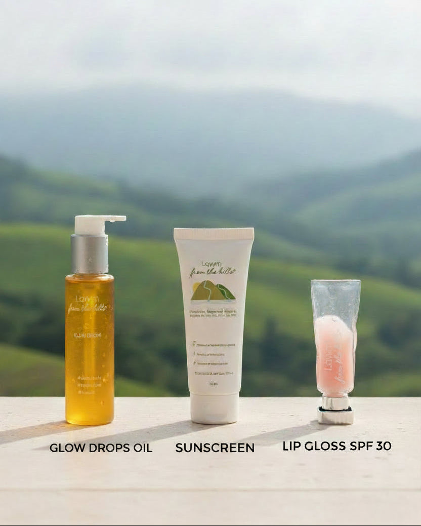Three skincare products (oil, sunscreen, lip gloss) with a hills background